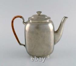 Just Andersen (1884-1943), Denmark. Art Deco tin coffee pot with wicker handle
