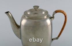 Just Andersen (1884-1943), Denmark. Art Deco tin coffee pot with wicker handle