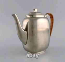 Just Andersen (1884-1943), Denmark. Art Deco tin coffee pot with wicker handle